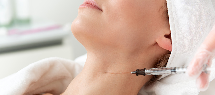 Woman receiving injection in neck