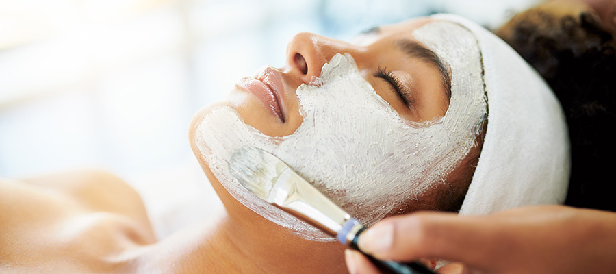 Woman getting facial treatment - model stock photo